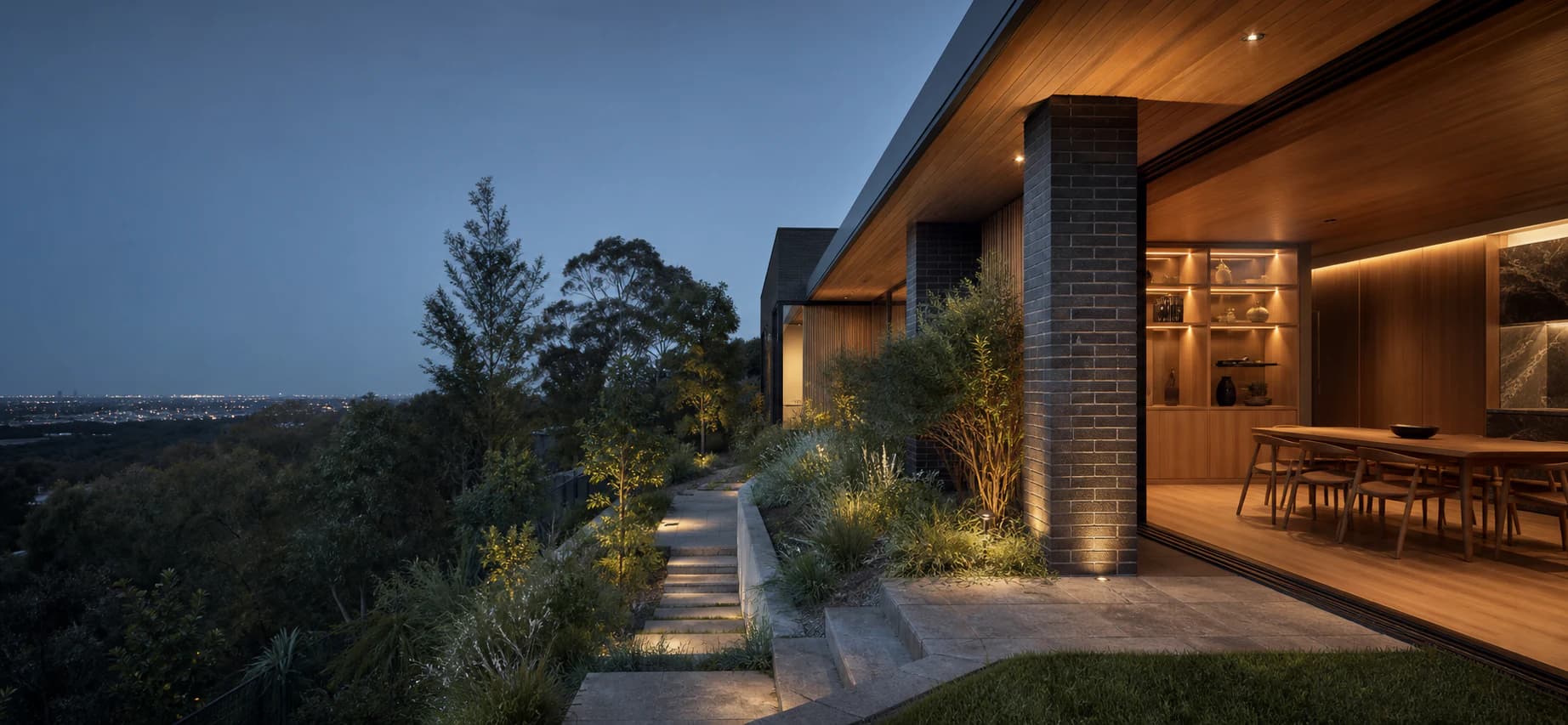 Contemporary Melbourne home opening to a landscaped hillside at blue hour