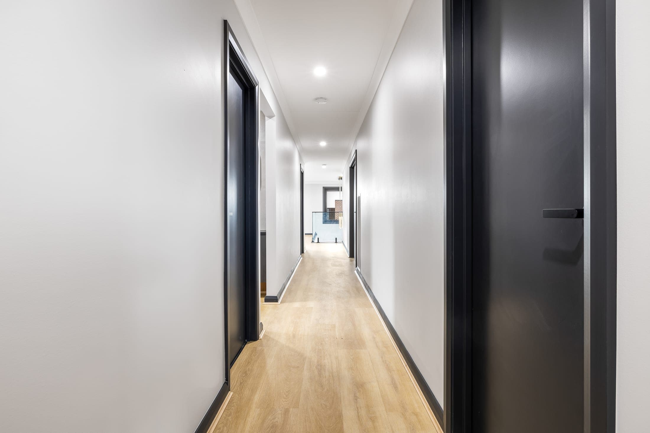 Internal hallway with bedroom doors in a dual occupancy home, City of Monash