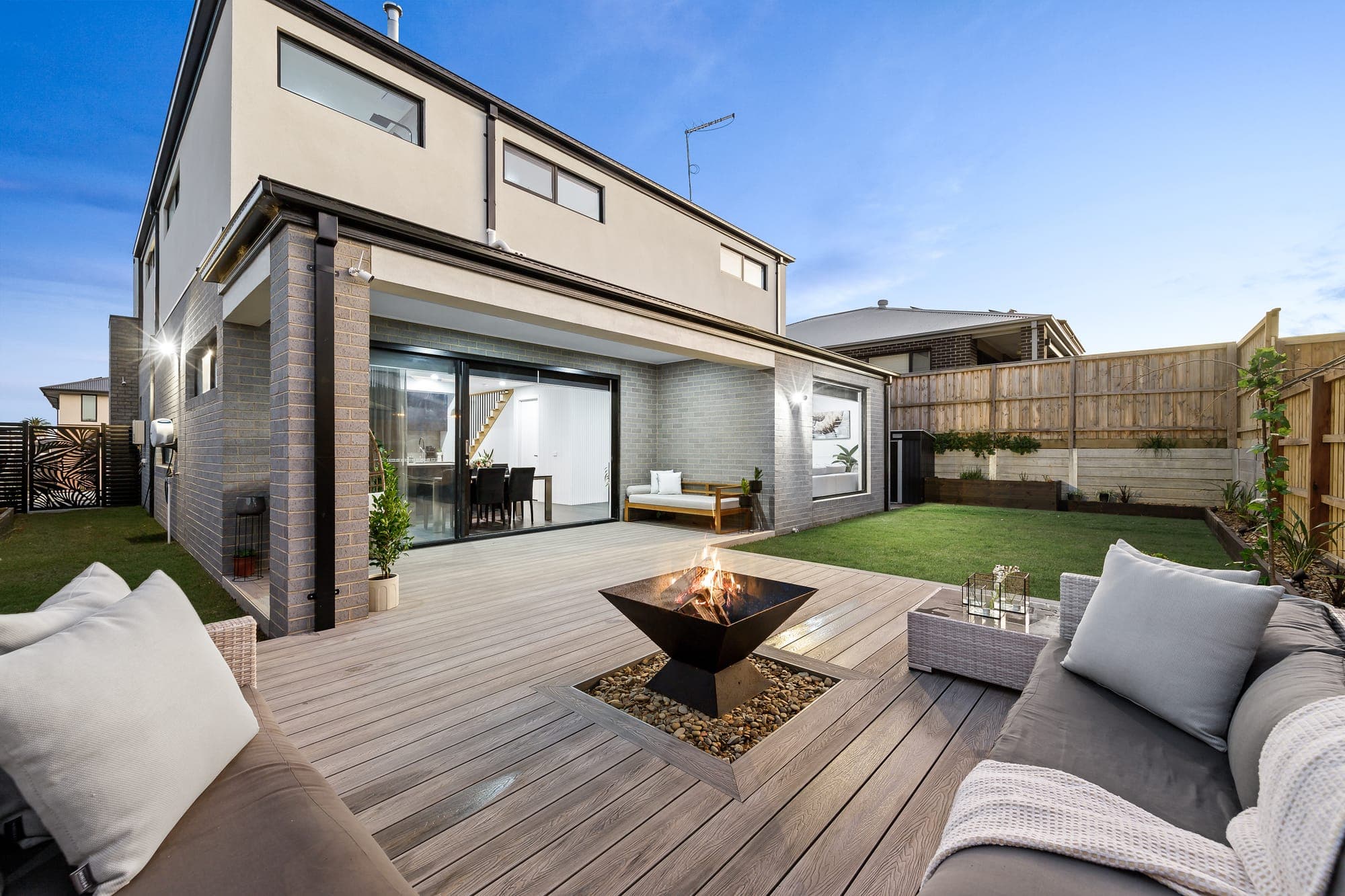 The Obsidian, alfresco deck with fire pit at dusk
