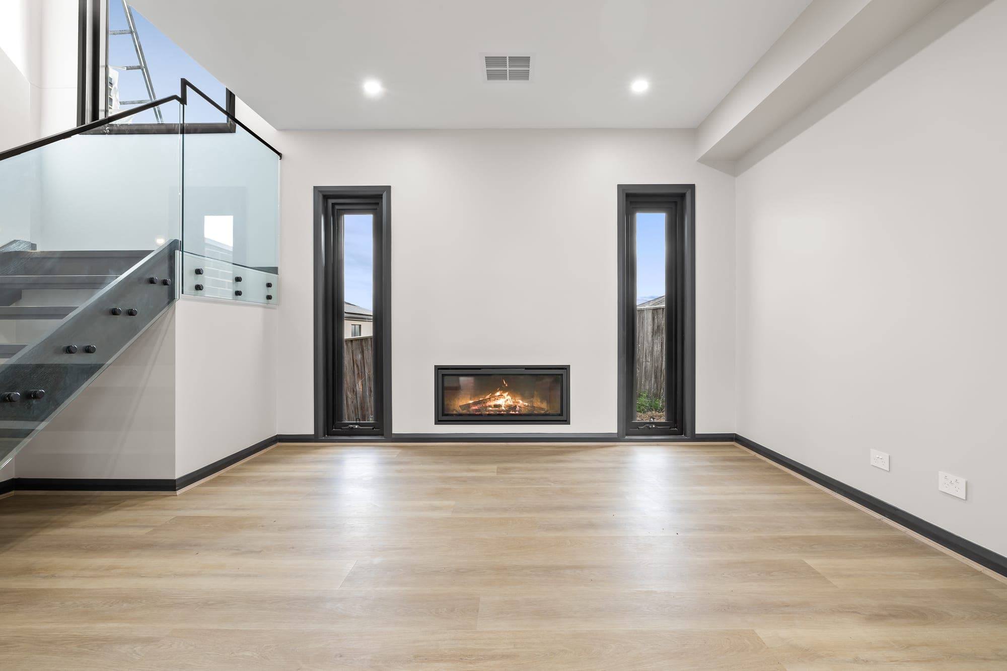 Project Solstice, lounge room with fireplace and split-level entry