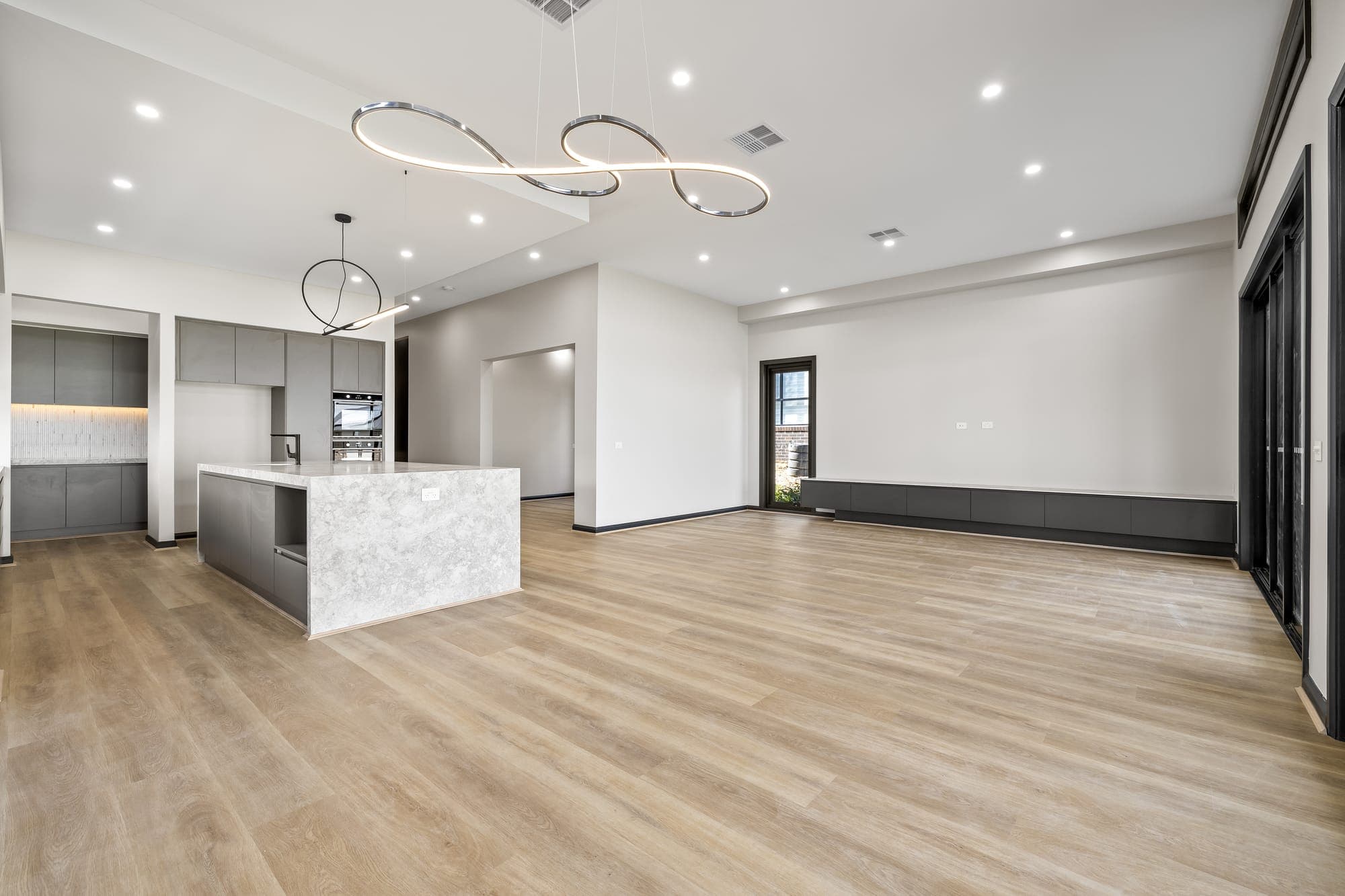 Project Solstice, open plan kitchen and living with timber floors
